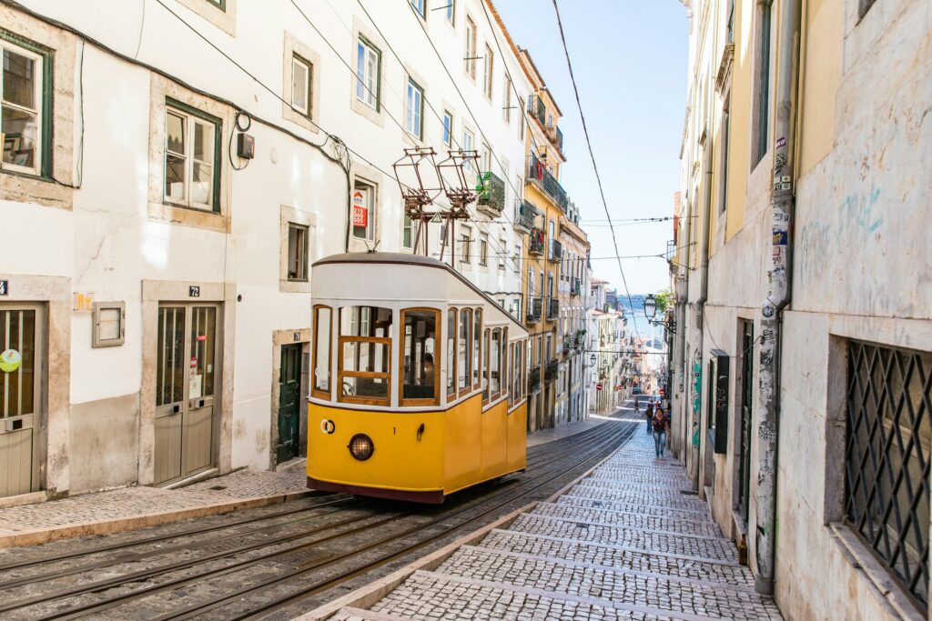 Historic yellow tram crossing Lisbon's old town during a private sightseeing experience in Portugal.